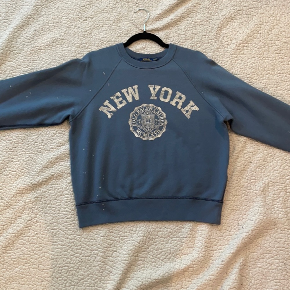 A blue Polo Shirt with New York written on it.